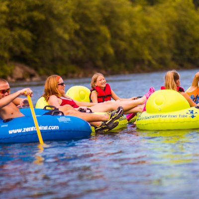 a group of people riding on a raft in a body of water