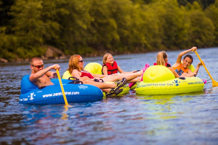a group of people riding on a raft in a body of water