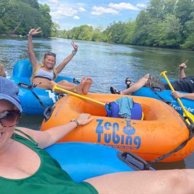 a group of people on a raft in a body of water
