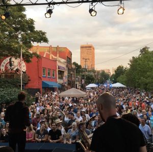Frederick Pabst et al. watching a band on stage in front of a crowd