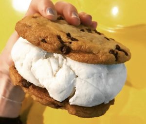 a hand holding a piece of food