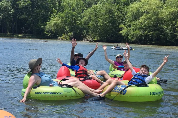 a group of people riding on a raft in a body of water