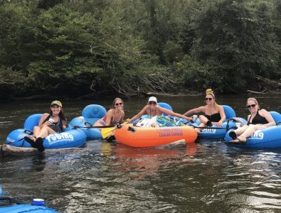 a group of people riding on a raft in the water