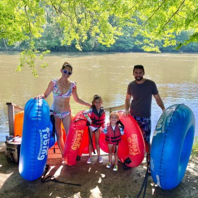 a group of people standing next to a body of water