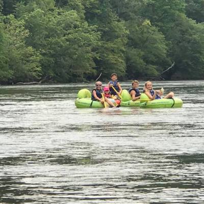 a group of people on a raft in a body of water