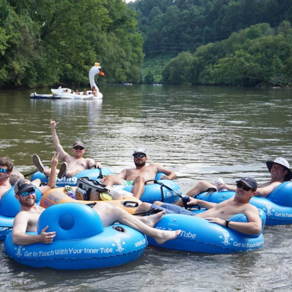 a group of people on a raft in a body of water