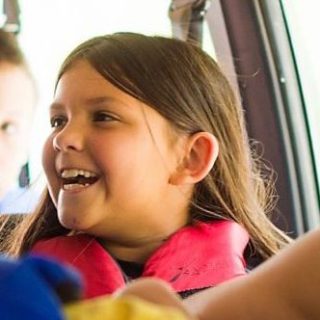 a little girl is looking at the camera