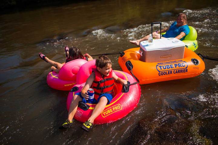 a little girl riding on a raft in a body of water