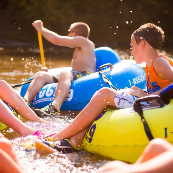 a group of people on a raft in a pool of water