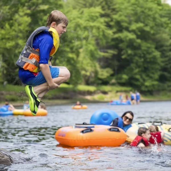 a group of people playing frisbee in the water