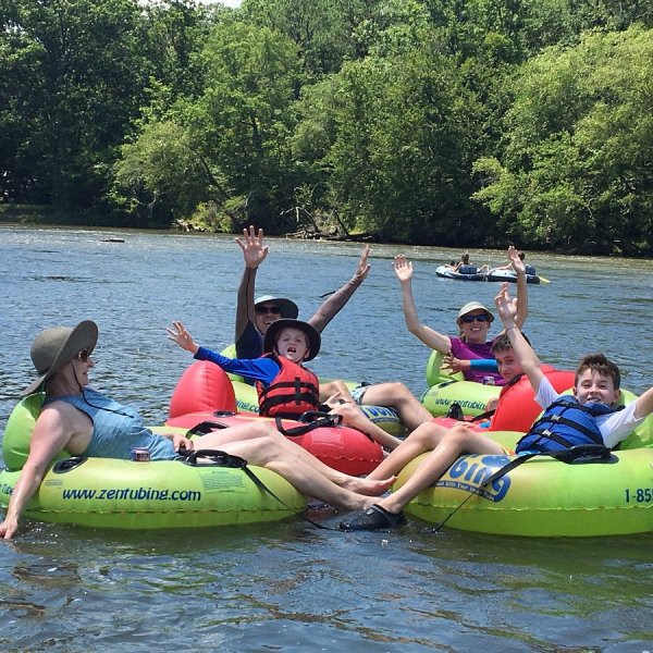 a group of people riding on a raft in a body of water